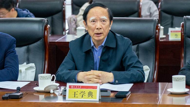 A person sitting at a desk Description automatically generated